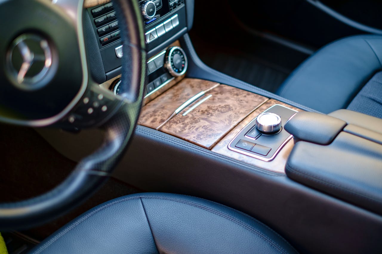 gallery-2 High-end car interior featuring leather seats and wood accents. Sleek and modern design.