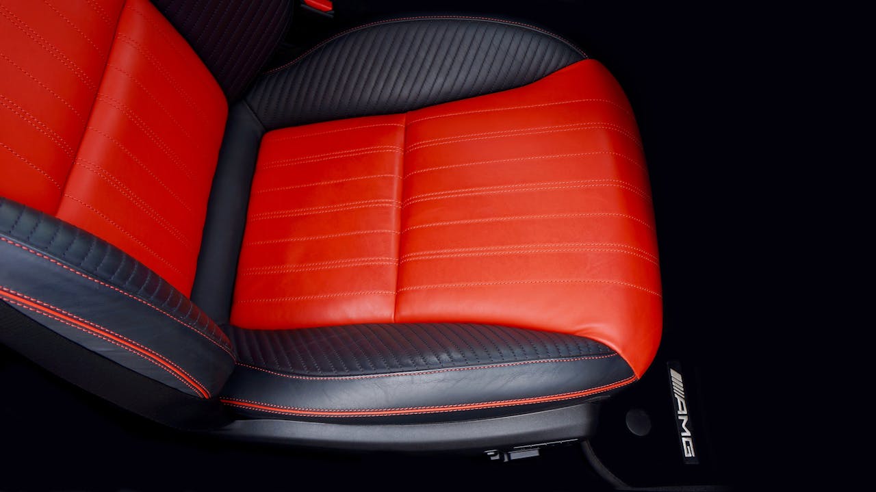 why-choose-us Top view of a luxury car seat with red and black leather, emphasizing modern automotive design.